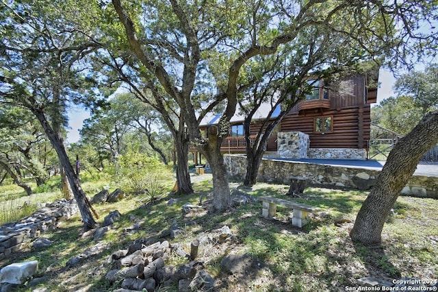 exterior details with log siding and stone siding
