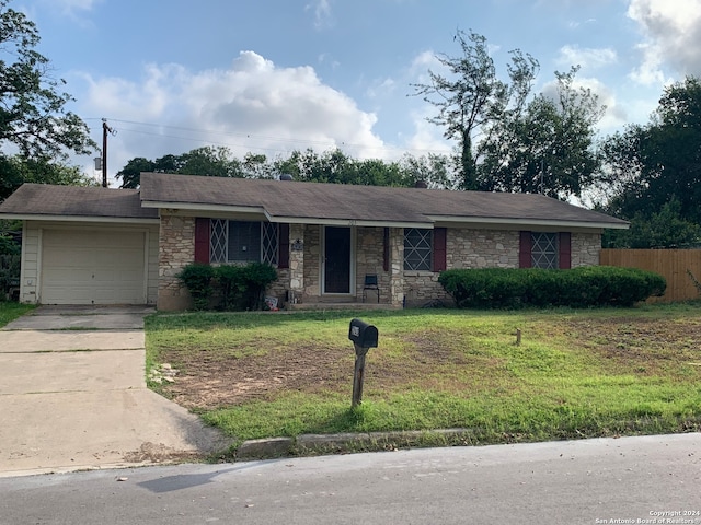 single story home featuring a front yard and a garage