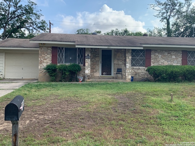 single story home featuring a garage and a front yard