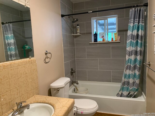 full bathroom featuring vanity, toilet, and shower / tub combo