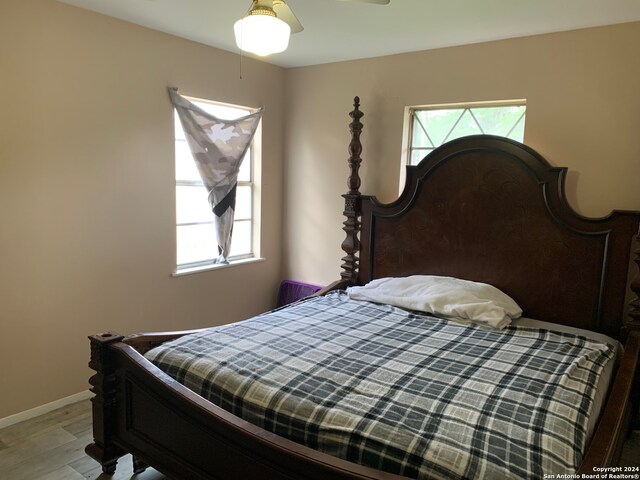 bedroom with ceiling fan and light hardwood / wood-style floors