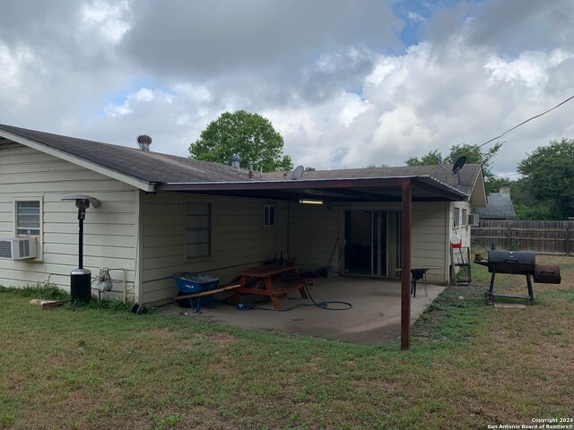 back of house with a patio area, a lawn, and cooling unit