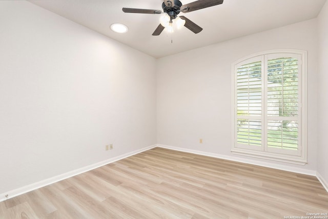 unfurnished room with baseboards, light wood finished floors, and ceiling fan