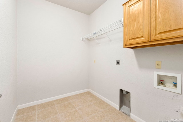washroom featuring cabinet space, electric dryer hookup, hookup for a washing machine, and baseboards