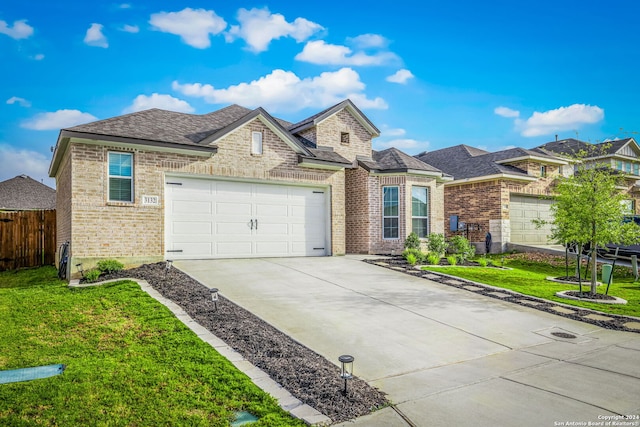 view of front of house with a garage and a front yard