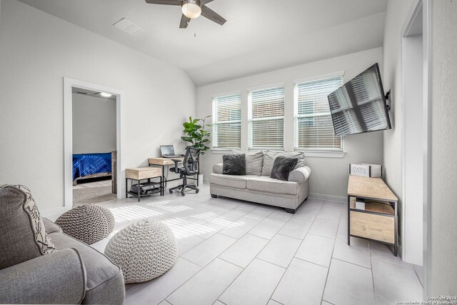 tiled living room with lofted ceiling and ceiling fan