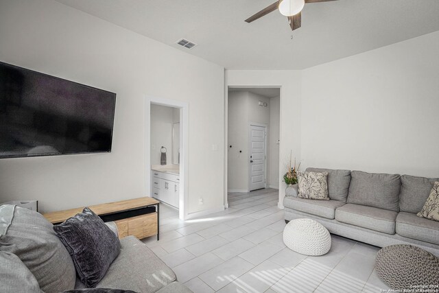 tiled living room featuring ceiling fan