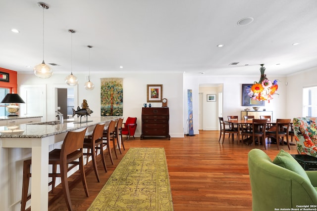 living room featuring ornamental molding and wood-type flooring