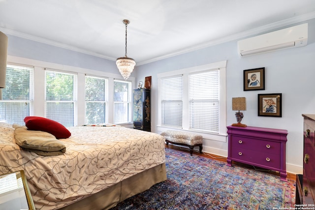 bedroom featuring ornamental molding, dark wood-type flooring, a wall unit AC, and a notable chandelier