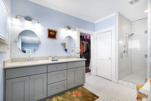 bathroom with crown molding, vanity, plenty of natural light, and a shower with door