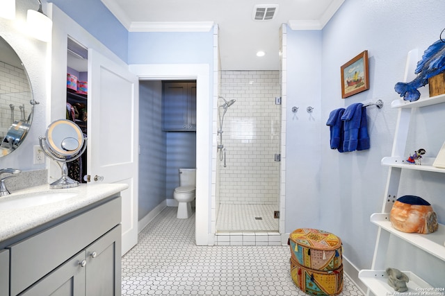 bathroom featuring a shower with door, vanity, toilet, and crown molding