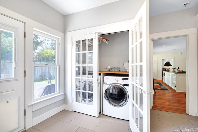 washroom with light hardwood / wood-style flooring and washer / dryer