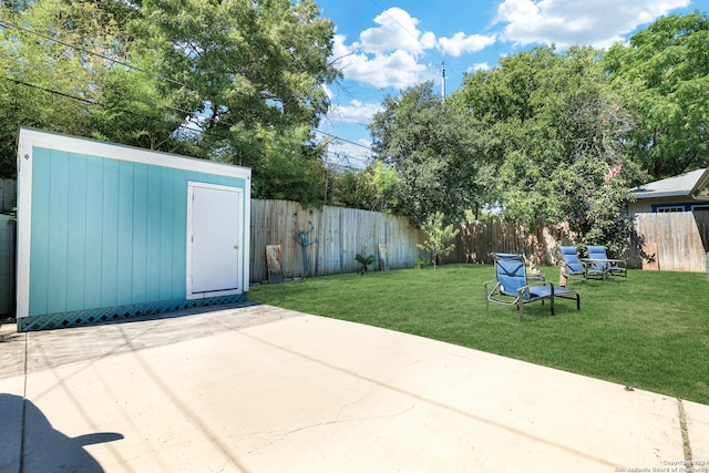 view of yard featuring a storage unit and a patio