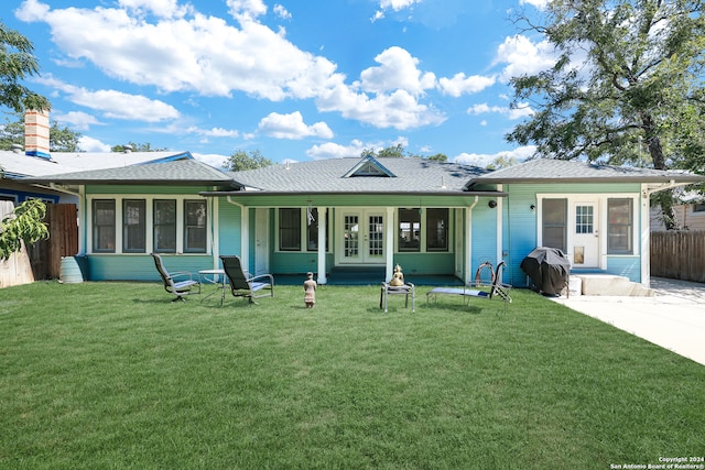 back of house featuring a lawn