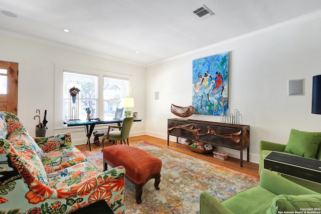 living room with hardwood / wood-style flooring and ornamental molding