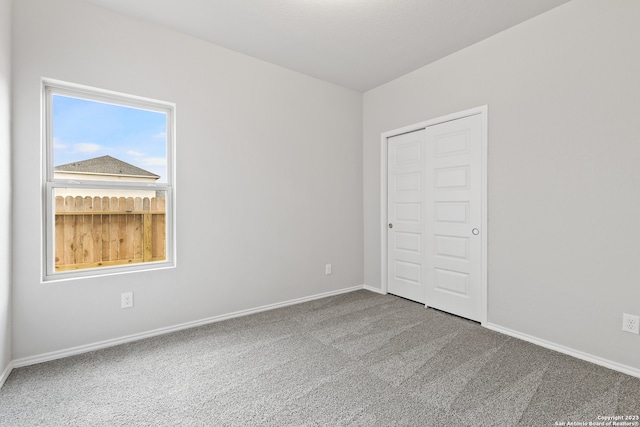 unfurnished bedroom with carpet flooring and a closet