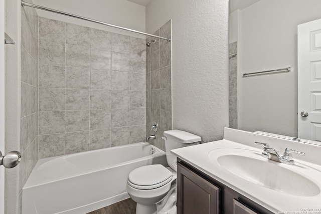 full bathroom featuring vanity, toilet, hardwood / wood-style floors, and tiled shower / bath