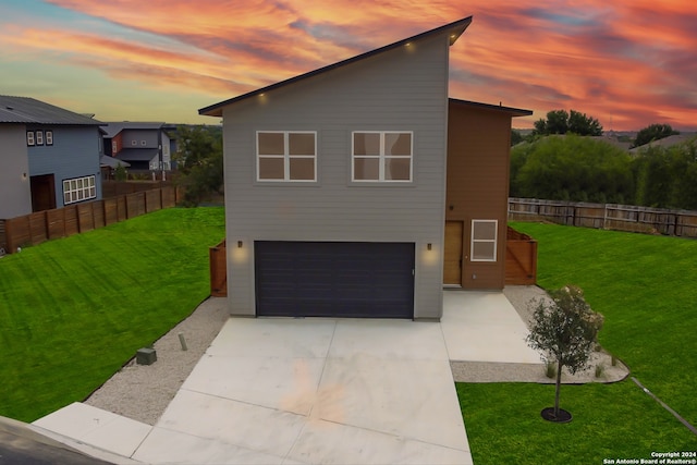 view of front of house featuring a garage and a yard