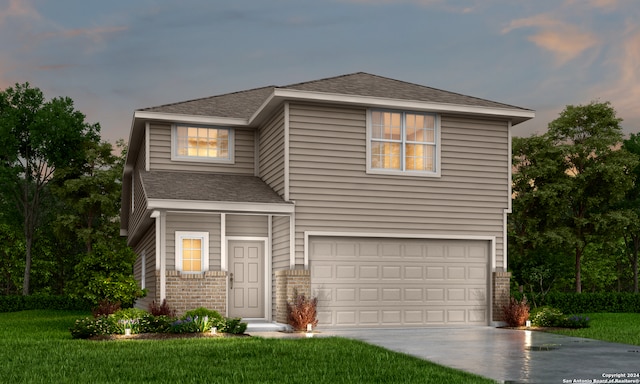 view of front facade with a yard and a garage