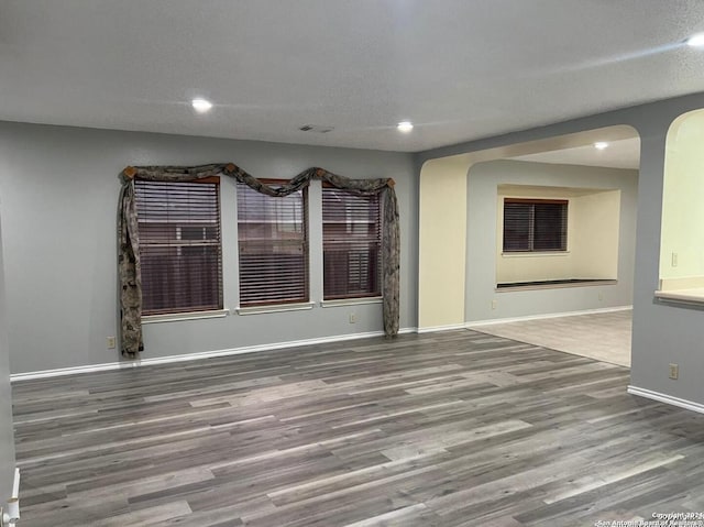 unfurnished room featuring a textured ceiling and wood-type flooring