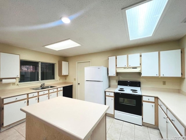 kitchen featuring electric range, freestanding refrigerator, a sink, white cabinets, and under cabinet range hood