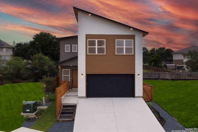 modern home with a garage and a lawn