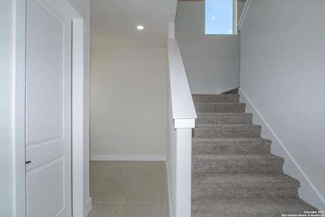 stairs featuring tile patterned floors