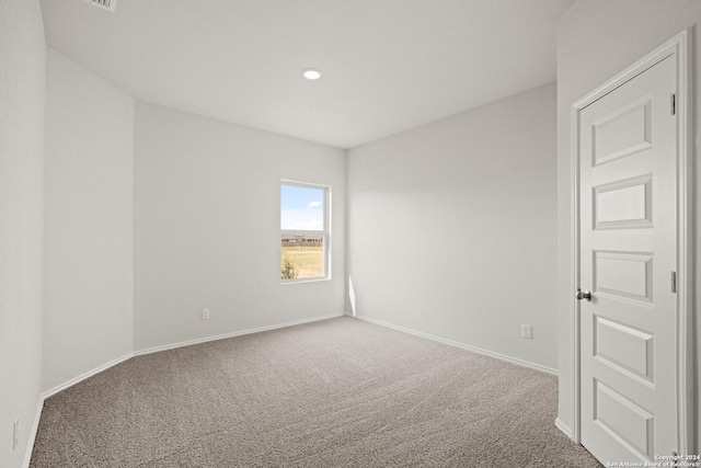 spare room featuring recessed lighting, baseboards, and carpet