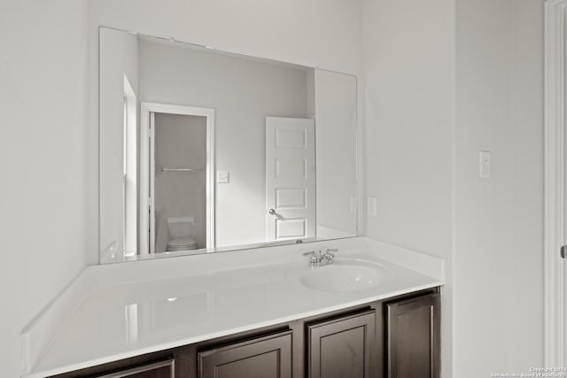 bathroom featuring toilet and vanity