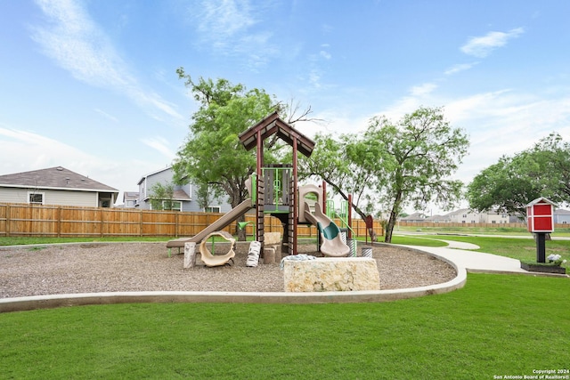 community playground featuring a lawn and fence