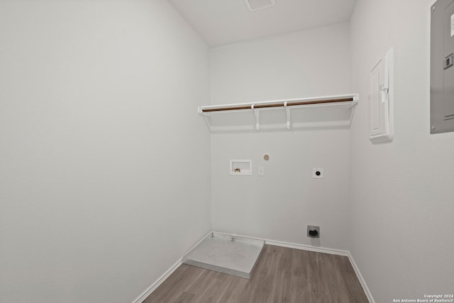 laundry area featuring baseboards, washer hookup, laundry area, wood finished floors, and electric dryer hookup