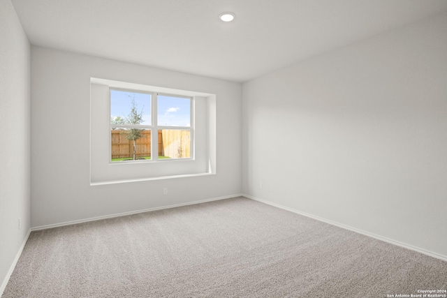 unfurnished room with recessed lighting, baseboards, and carpet floors