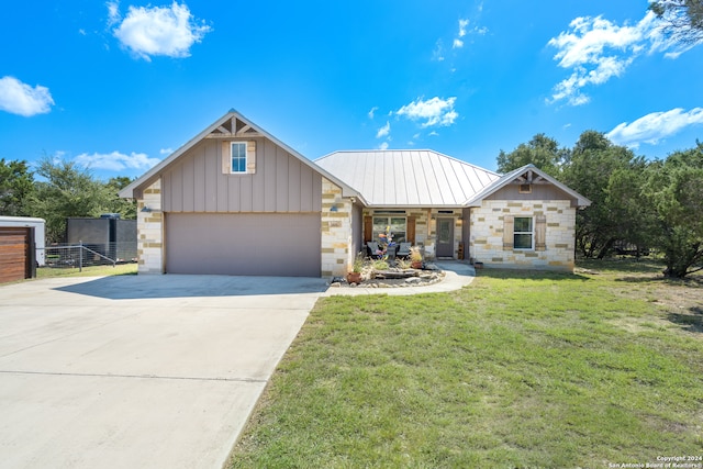 view of front of property featuring a garage and a front lawn