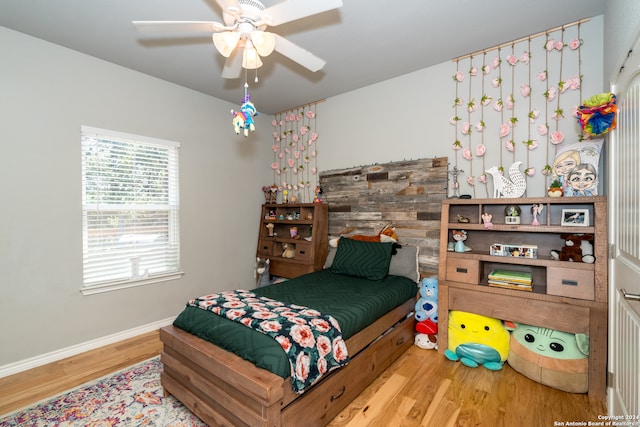 bedroom with ceiling fan and hardwood / wood-style flooring