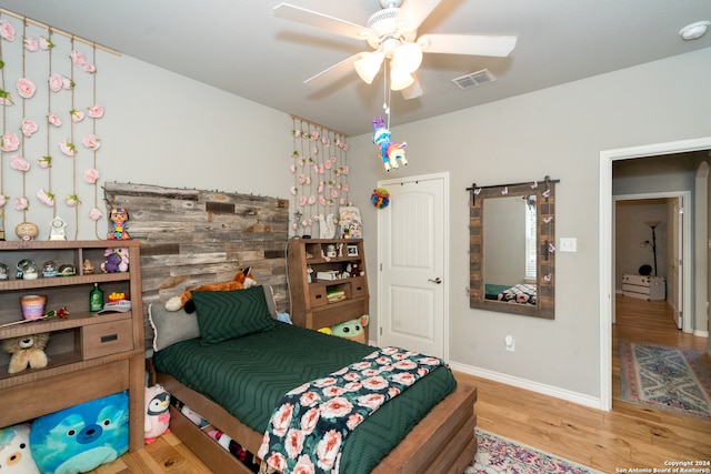 bedroom featuring ceiling fan and hardwood / wood-style flooring