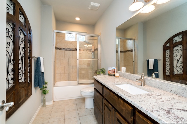 full bathroom with tile patterned flooring, toilet, combined bath / shower with glass door, and vanity