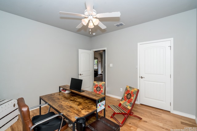 home office with ceiling fan and light hardwood / wood-style flooring