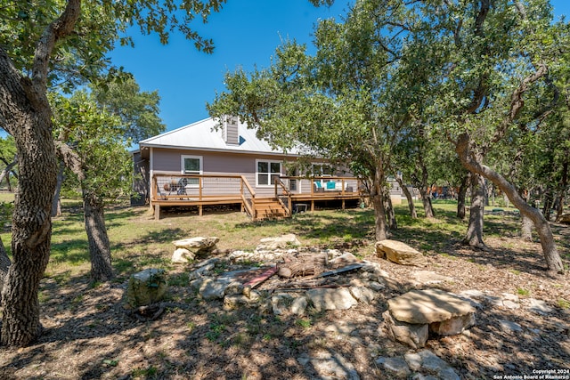 back of property featuring a wooden deck