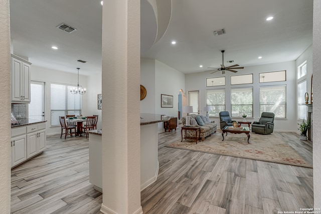 living room featuring light hardwood / wood-style flooring and ceiling fan