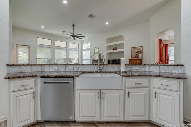 kitchen featuring stainless steel dishwasher, a sink, visible vents, a ceiling fan, and built in features