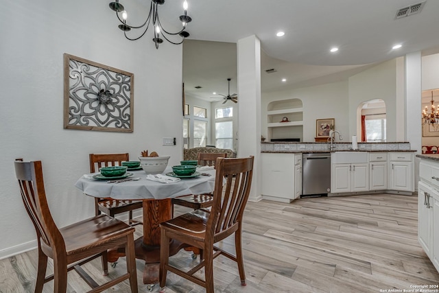 dining area with visible vents, built in shelves, recessed lighting, light wood-type flooring, and ceiling fan with notable chandelier