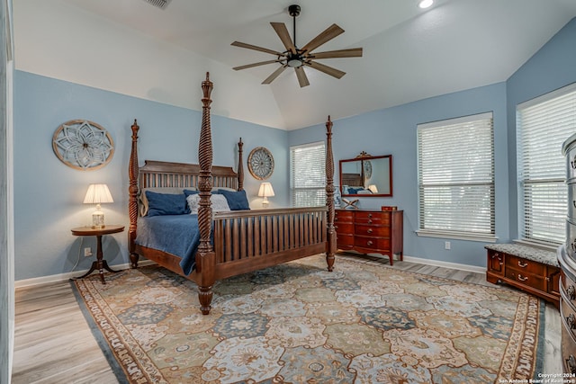 bedroom featuring baseboards, ceiling fan, vaulted ceiling, and light wood finished floors