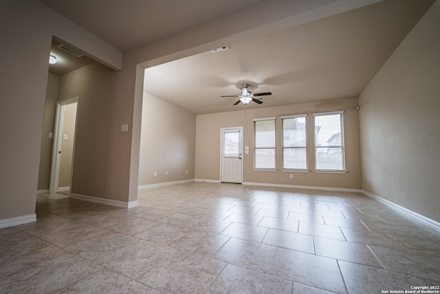 empty room with ceiling fan and light tile patterned floors