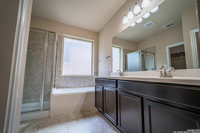 bathroom featuring tile patterned floors, visible vents, a garden tub, a stall shower, and double vanity