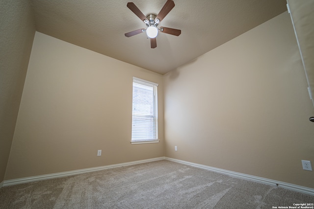 spare room featuring lofted ceiling, ceiling fan, and carpet