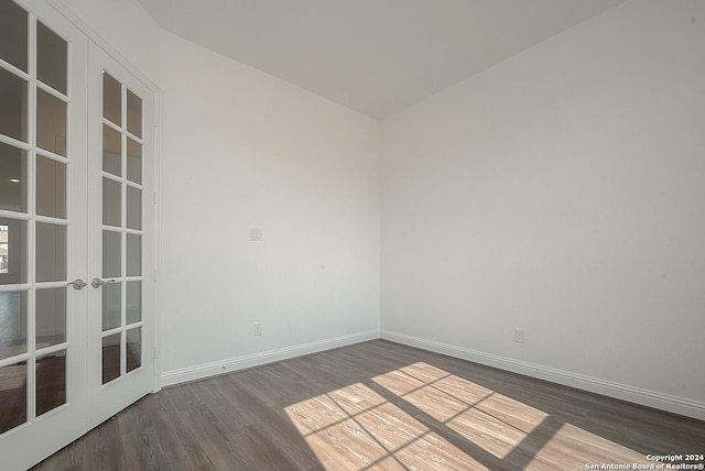 empty room featuring dark hardwood / wood-style flooring and french doors