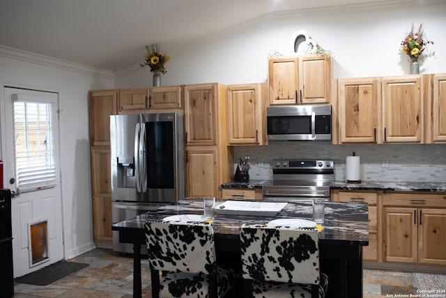 kitchen featuring backsplash, light brown cabinetry, stainless steel appliances, lofted ceiling, and ornamental molding