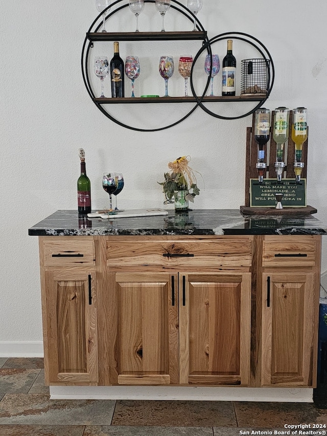 bar with dark stone countertops