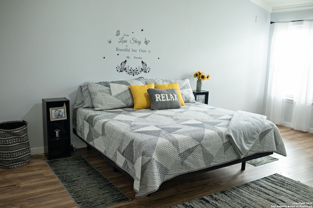 bedroom featuring ornamental molding and hardwood / wood-style floors