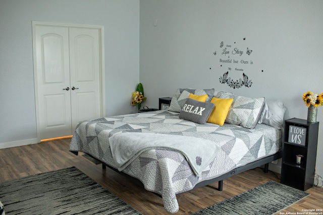 bedroom featuring hardwood / wood-style floors and a closet